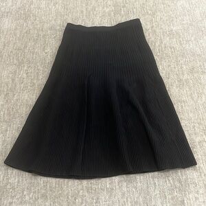 Black pleated below the knee skirt